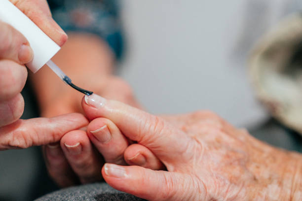 Close-Up Shot of an Elderly Senior Caucasian Woman Getting a Manicure at Home by a Professional Caregiver